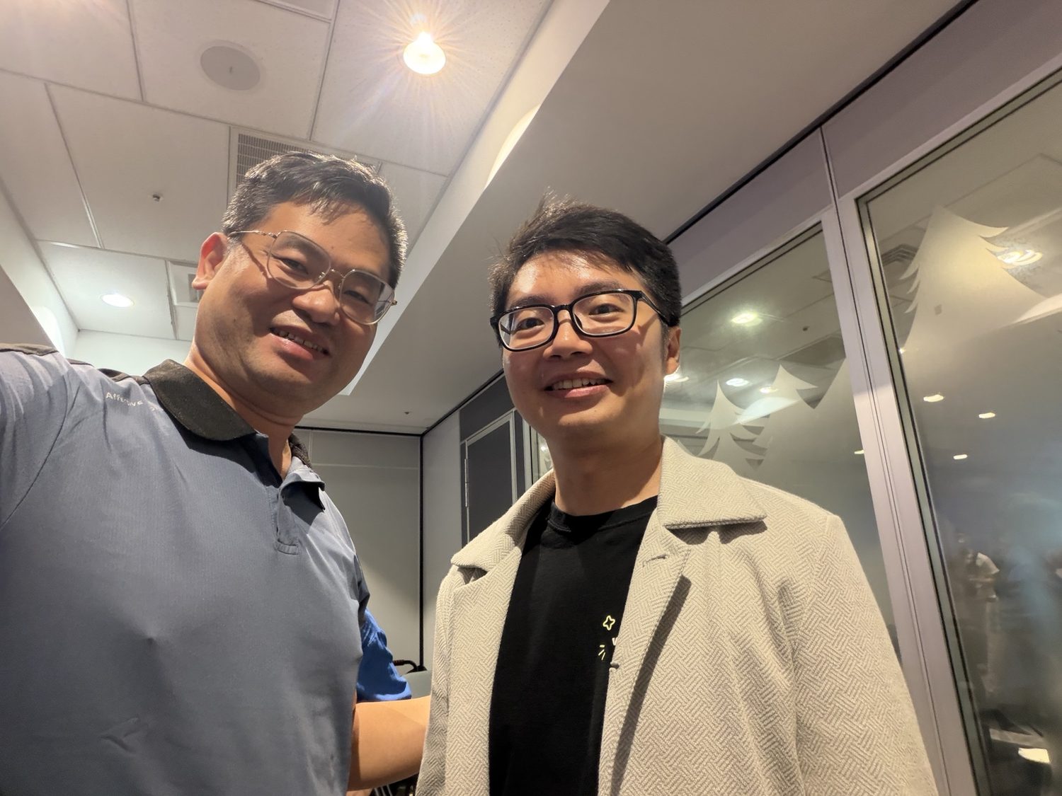 Joel Lin with a technology specialist